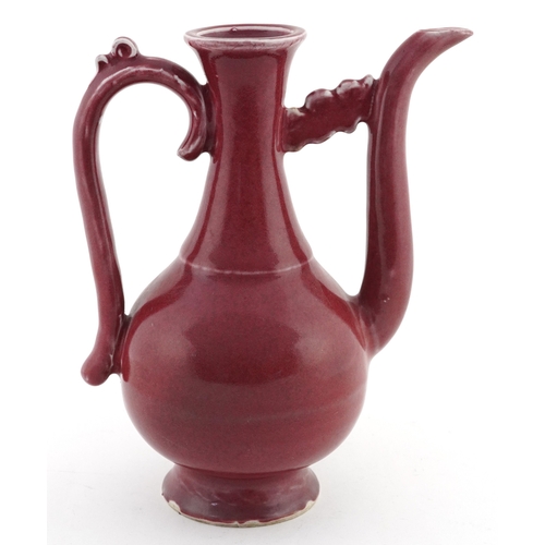 58 - Chinese porcelain red glazed ewer bearing four figure character mark to the base, 20cm high.