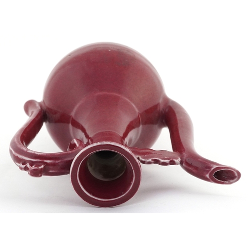 58 - Chinese porcelain red glazed ewer bearing four figure character mark to the base, 20cm high.