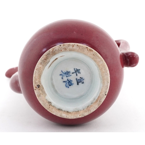 58 - Chinese porcelain red glazed ewer bearing four figure character mark to the base, 20cm high.