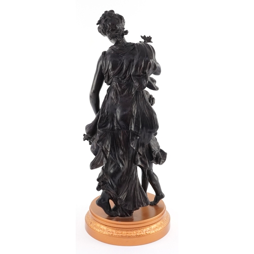 10 - Bronzed spelter figure of a maiden and child with a flower basket, 50cm high.