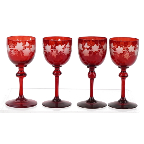 35 - Eight antique Bohemian cranberry glasses etched with grapevines, 15cm high.