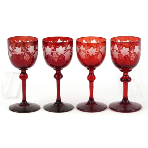 35 - Eight antique Bohemian cranberry glasses etched with grapevines, 15cm high.