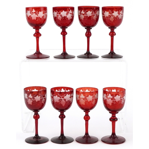 35 - Eight antique Bohemian cranberry glasses etched with grapevines, 15cm high.