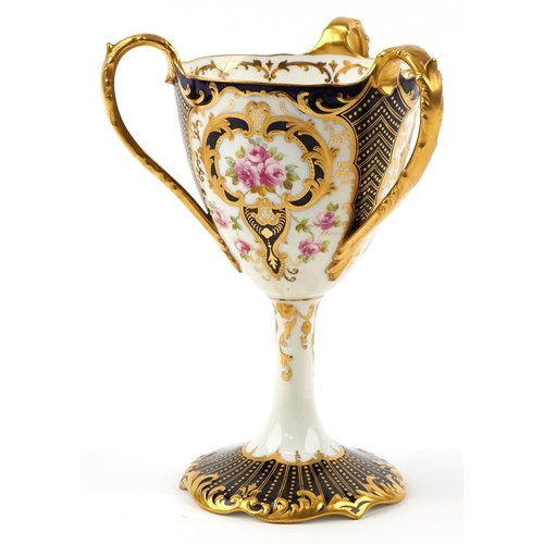 29 - Wedgwood porcelain three handled pedestal loving cup finely hand painted and gilded with roses, 22cm... 