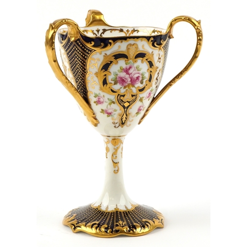 29 - Wedgwood porcelain three handled pedestal loving cup finely hand painted and gilded with roses, 22cm... 