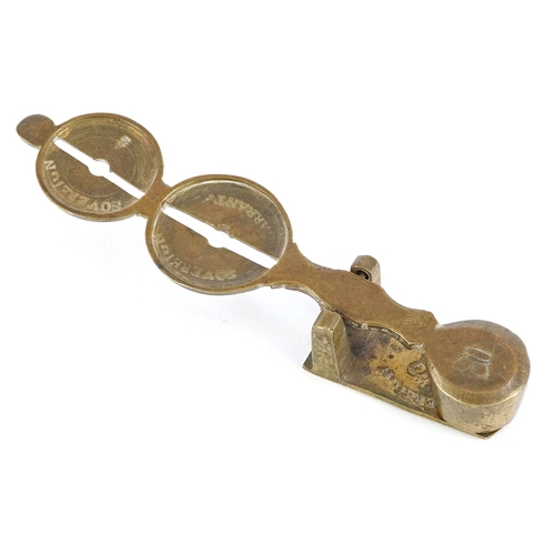 48 - Set of late 19th century antique brass sovereign scales, 10cm in length.
