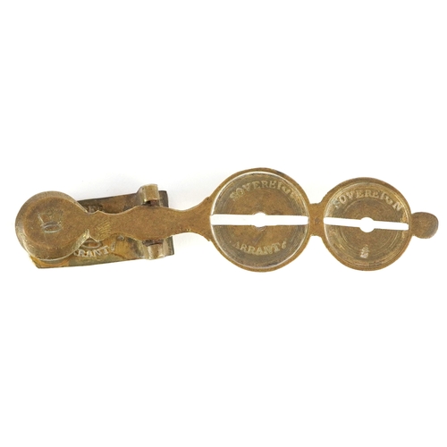 48 - Set of late 19th century antique brass sovereign scales, 10cm in length.