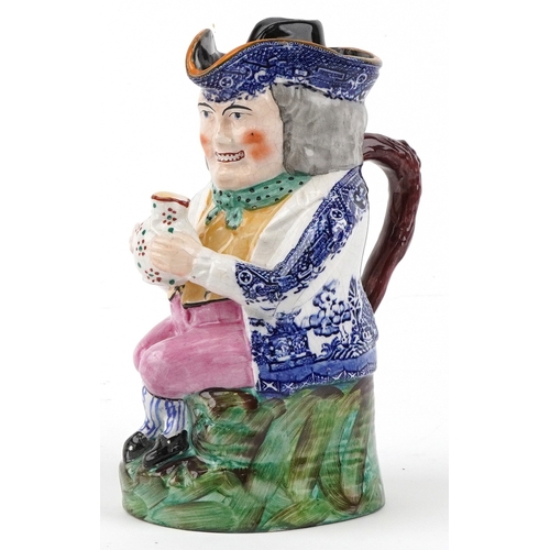 Victorian Staffordshire pottery Toby jug and cover transfer printed in the Willow Pattern and having hand painted decoration, 25cm high.