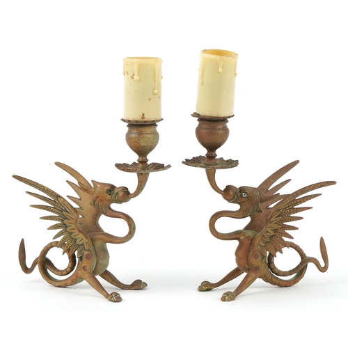 Pair of Victorian gothic winged dragon brass candlesticks converted for electrical use, 25cm high.