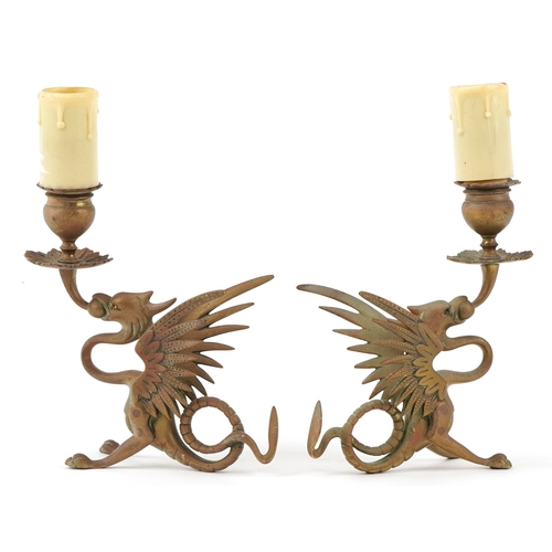 363 - Pair of Victorian gothic winged dragon brass candlesticks converted for electrical use, 25cm high.