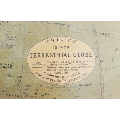 353 - George Philip & Son twelve inch terrestrial globe raised on a plinth base, 34cm high.