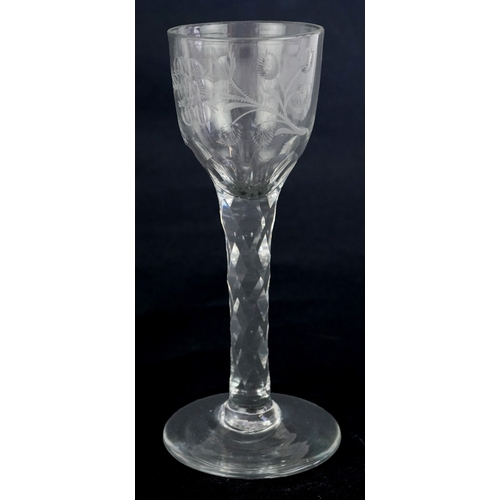 107 - 18th century Jacobite wine glass engraved with rosebuds and an insect, 15cm high.