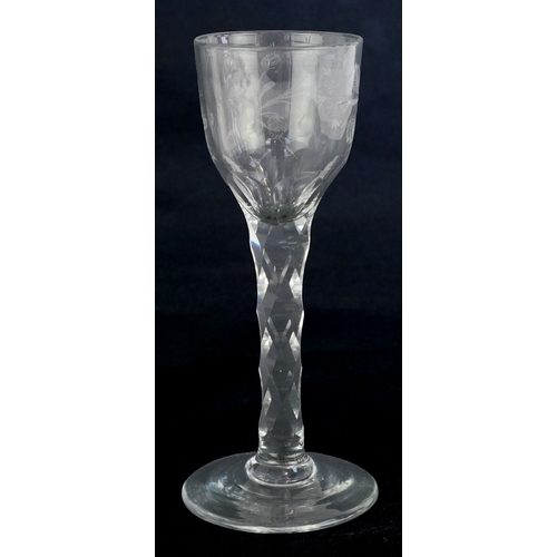 107 - 18th century Jacobite wine glass engraved with rosebuds and an insect, 15cm high.