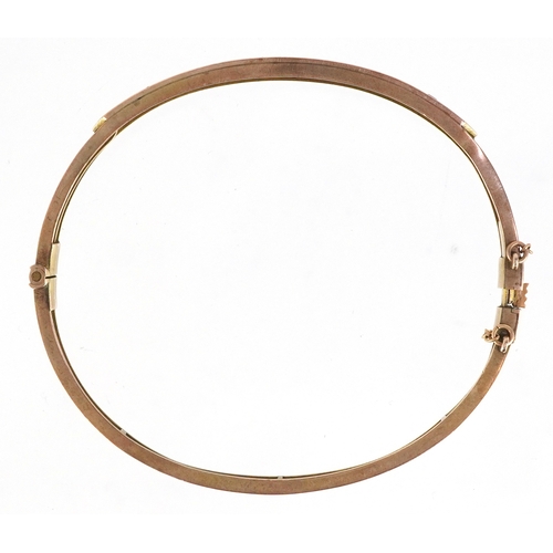 3042 - Edwardian 9ct gold ruby and diamond bangle, 6cm wide, 7.8g.