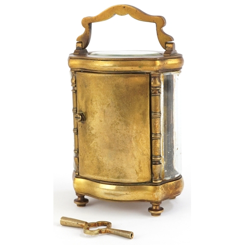 76 - Gilt brass serpentine glass carriage clock having enamelled dial with Roman numerals, 13cm high.