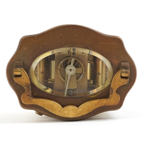 76 - Gilt brass serpentine glass carriage clock having enamelled dial with Roman numerals, 13cm high.