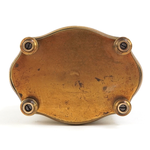 76 - Gilt brass serpentine glass carriage clock having enamelled dial with Roman numerals, 13cm high.