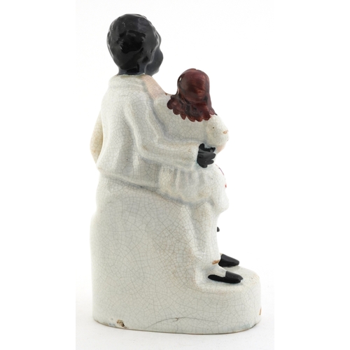 6 - Victorian Staffordshire pottery figure group of Uncle Tom & Eva, 21.5cm high.