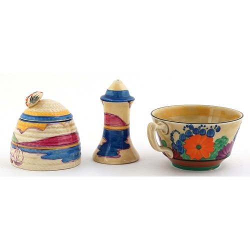 152 - Clarice Cliff, Art Deco pottery comprising a teacup hand painted in the Gayday pattern, a salt shake... 