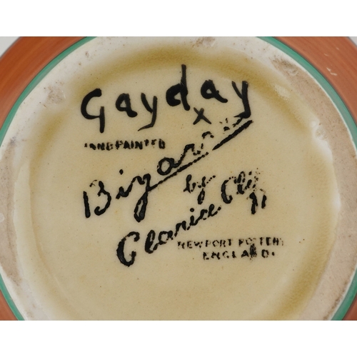152 - Clarice Cliff, Art Deco pottery comprising a teacup hand painted in the Gayday pattern, a salt shake... 