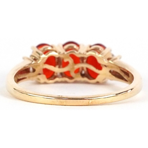 3015 - 14ct gold diamond and red stone ring, possibly fire opal, size R, 2.9g.