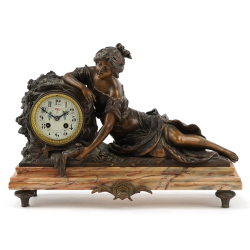 75 - After Moreau, early 20th century patinated spelter mantle clock cast with a recumbent female and emb... 