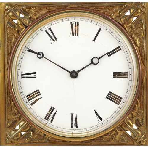 214 - Antique brass strut clock embossed with masks and engraved with fish, the enamelled dial having Roma... 