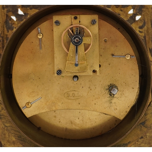 214 - Antique brass strut clock embossed with masks and engraved with fish, the enamelled dial having Roma... 