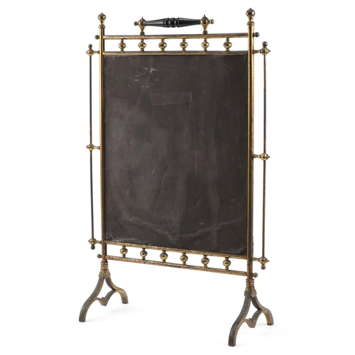 260 - Early 20th century brass and mirrored fire screen reverse painted with orchids, 84cm high.
