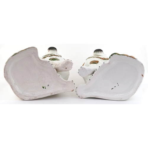 229 - Pair of Staffordshire style seated Spaniels with hand painted decoration, 22.5cm high.