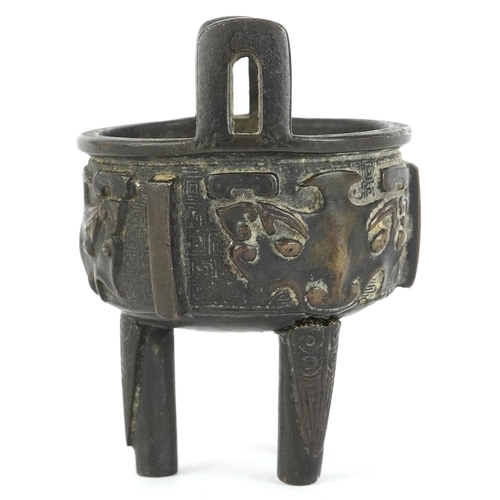 299 - Chinese bronze tripod censer decorated with bats, 8cm high.
