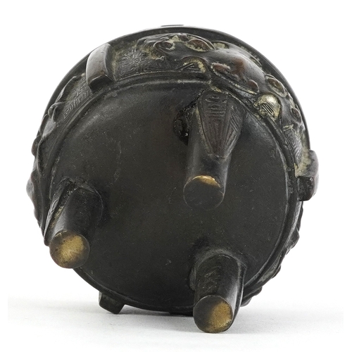 299 - Chinese bronze tripod censer decorated with bats, 8cm high.