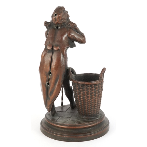 42 - Antique bronzed spelter striker in the form of a figure with cane and basket, 19cm high.