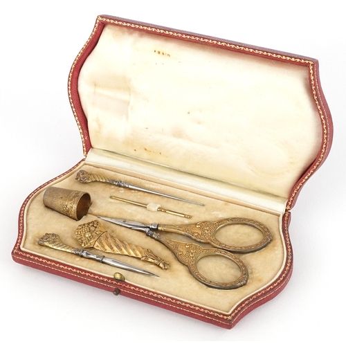 xxx need the silver mark which is on the needle case 19th century continental silver gilt sewing set including a cornucopia needle case, silver handled embroidery scissors and thimble, housed in a fitted velvet lined case, 16cm wide.