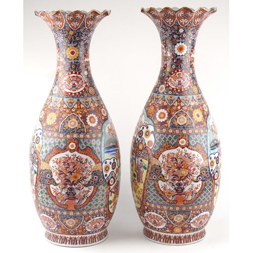 52 - Pair of very large floor standing Japanese Imari vases decorated with panels of figures in landscape... 