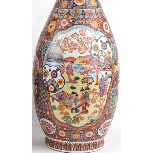 52 - Pair of very large floor standing Japanese Imari vases decorated with panels of figures in landscape... 