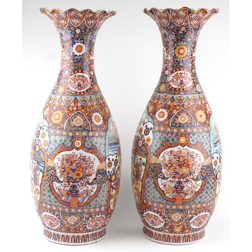 52 - Pair of very large floor standing Japanese Imari vases decorated with panels of figures in landscape... 