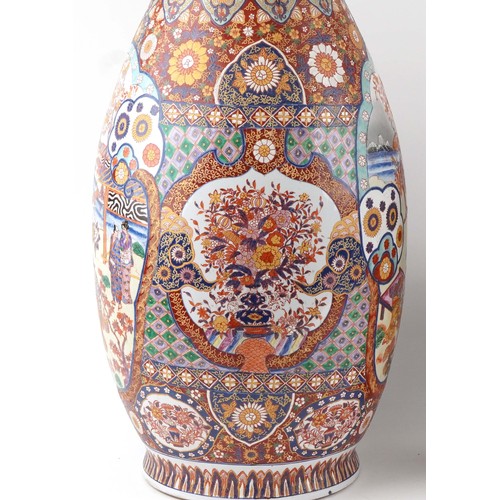 52 - Pair of very large floor standing Japanese Imari vases decorated with panels of figures in landscape... 