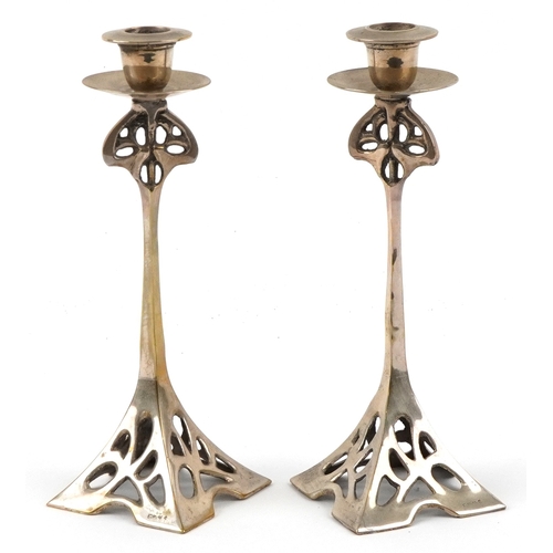 31 - Pair of Arts & Crafts brass candlesticks, 24cm high.