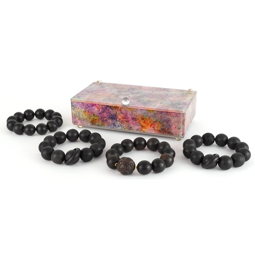 Four Chinese carved wooden bead bracelets, two with Chinese coin motifs ...