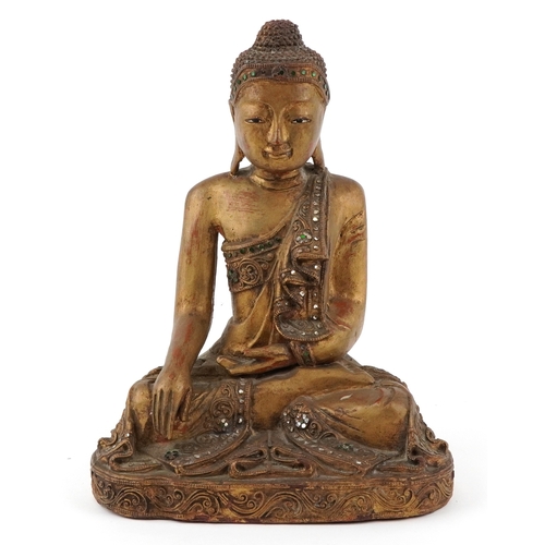  Burmese carved wood seated Buddha decorated with green and clear glass inlay, 34.5cm high.