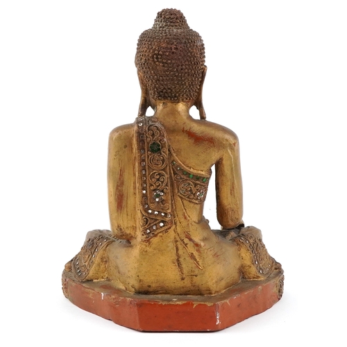  Burmese carved wood seated Buddha decorated with green and clear glass inlay, 34.5cm high.