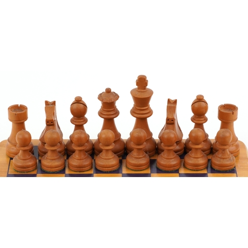  Vintage carved wood Staunton pattern chess set with a chess board, the largest piece 9.5cm high, the... 