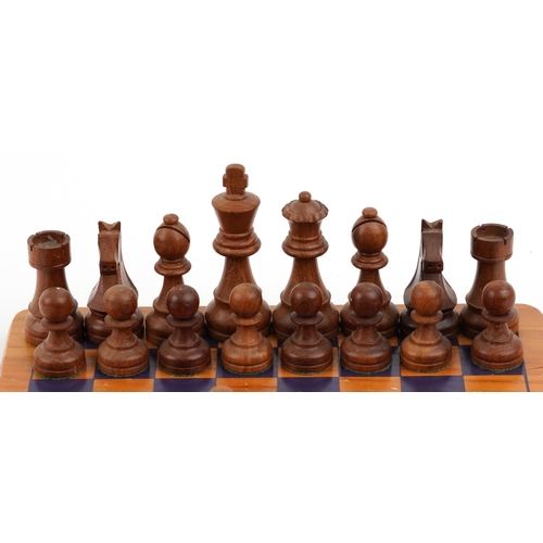  Vintage carved wood Staunton pattern chess set with a chess board, the largest piece 9.5cm high, the... 