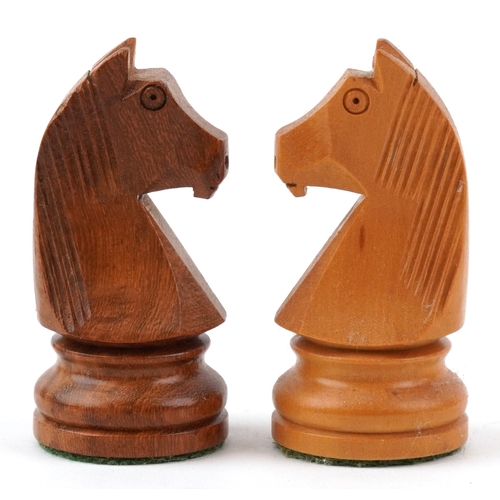  Vintage carved wood Staunton pattern chess set with a chess board, the largest piece 9.5cm high, the... 