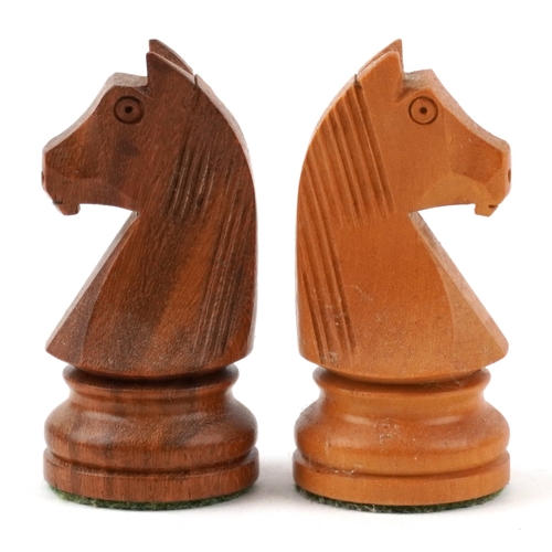  Vintage carved wood Staunton pattern chess set with a chess board, the largest piece 9.5cm high, the... 
