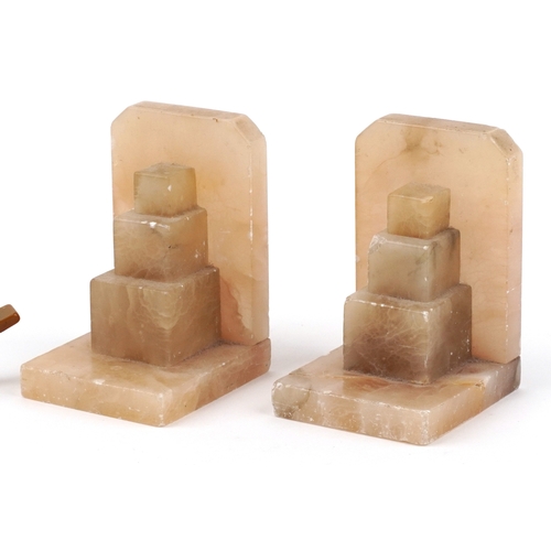 Three Art Deco Bakelite napkin rings in the form of birds and a pair of Art Deco onyx bookends, the ... 