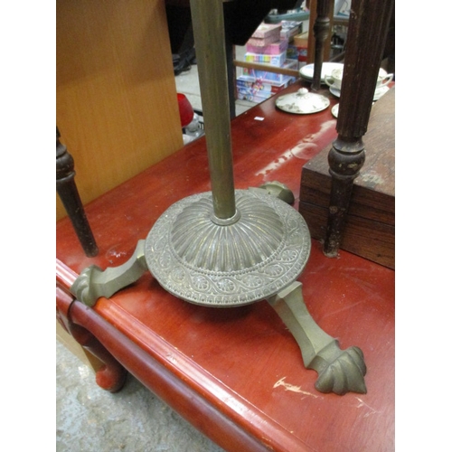 97 - A VINTAGE BRASS STANDARD LAMP WITH DECORATIVE BASE ON 3 LEGS