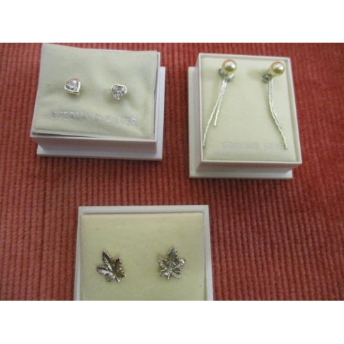 10 - 3 PAIRS OF STERLING SILVER EARRINGS 1 HEART SHAPED WITH WHITE STONE 1 MAPLE LEAF AND THE OTHER PEARL... 