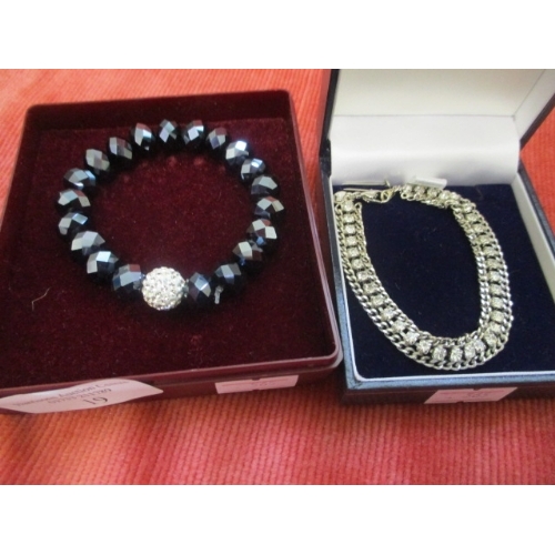 19 - DIAMANTE BRACELET AND A BLACK STONE AND DIAMANTE BRACELET